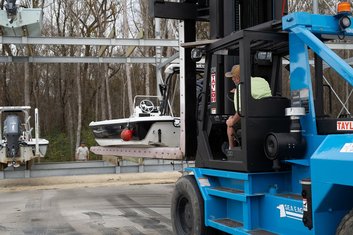 Forklift launching a boat from dry stack storage at Hidden Cove Marina