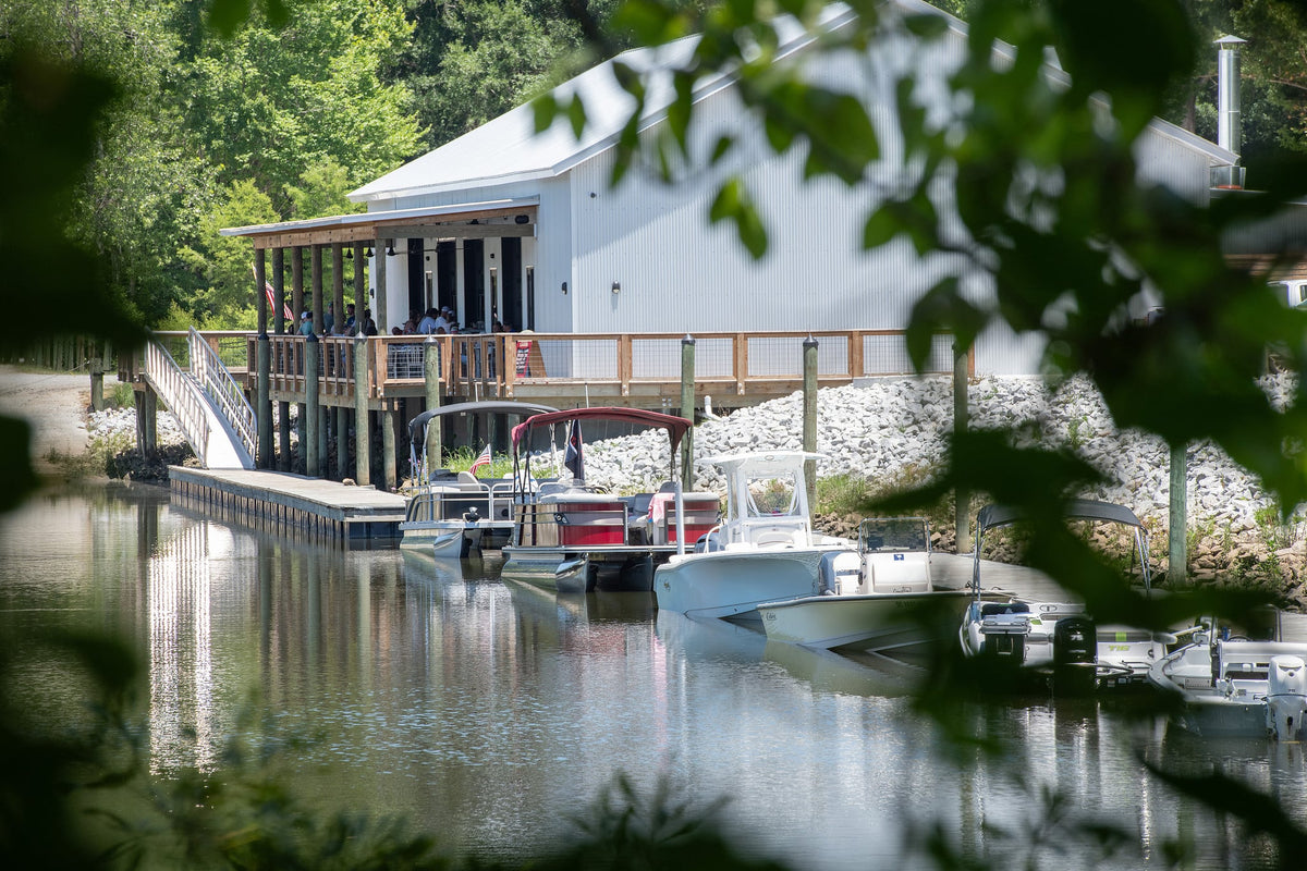 Hidden Cove Marina boathouse and docks seen through the trees on the Cooper River