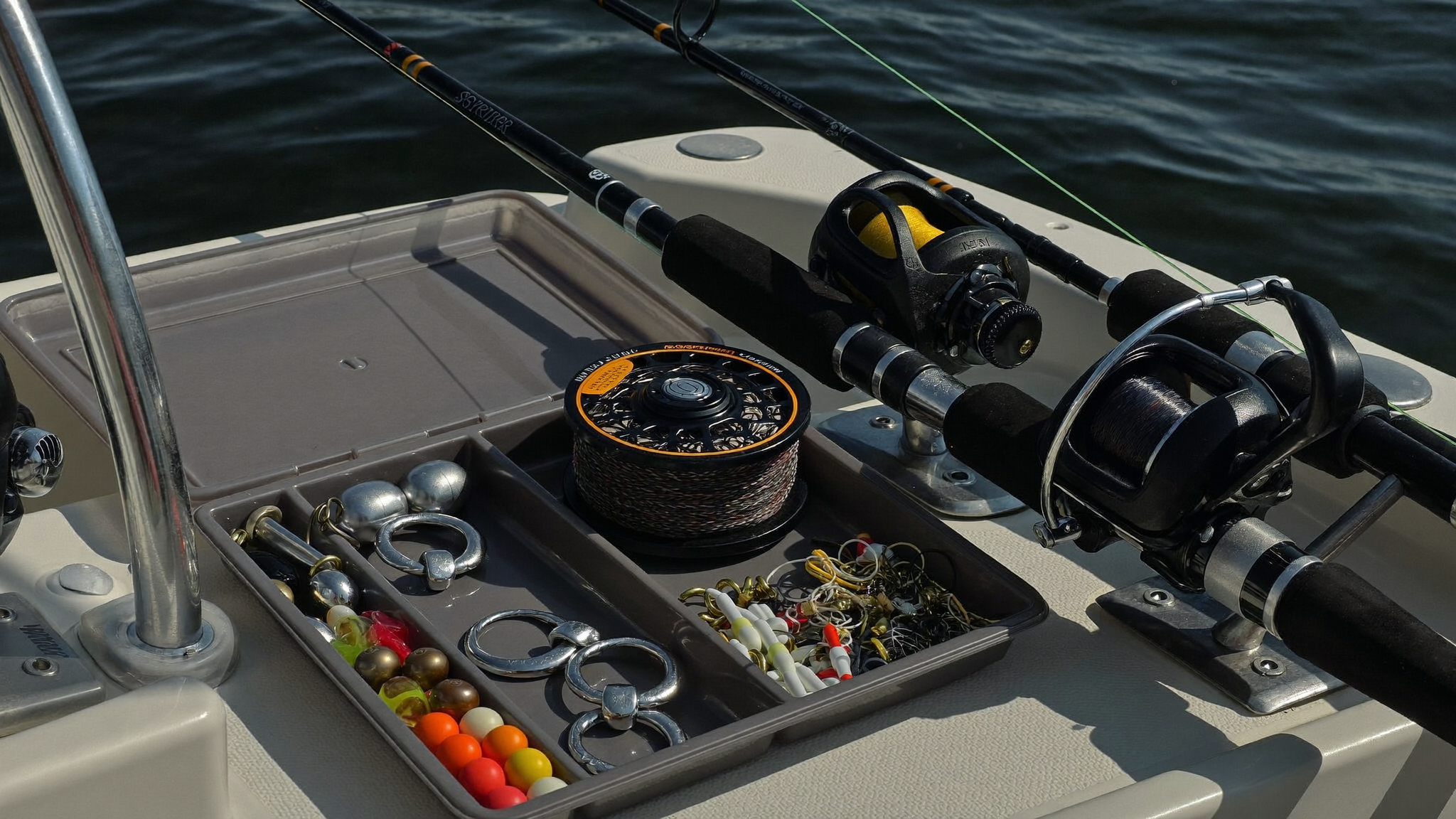 Catfish tackle tray with circle hooks, sinkers and heavy rods on a boat deck