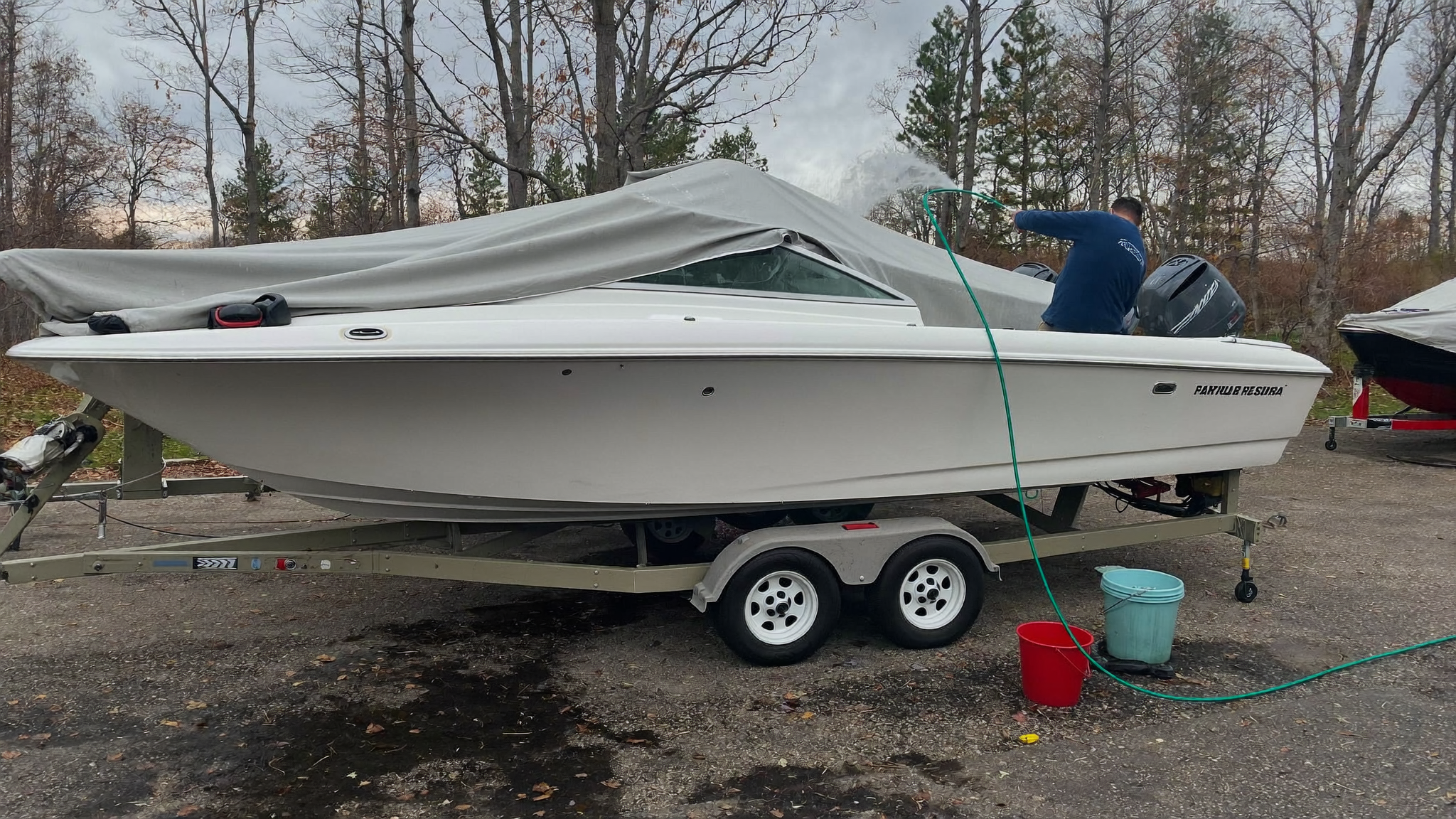 Boat on a trailer being rinsed and prepped for winter storage at a South Carolina marina